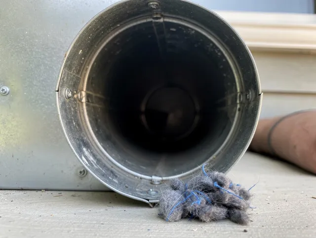 Berlin Dryer Vent Cleaning technician using specialized equipment to clear severe dryer vent blockage in Berlin
